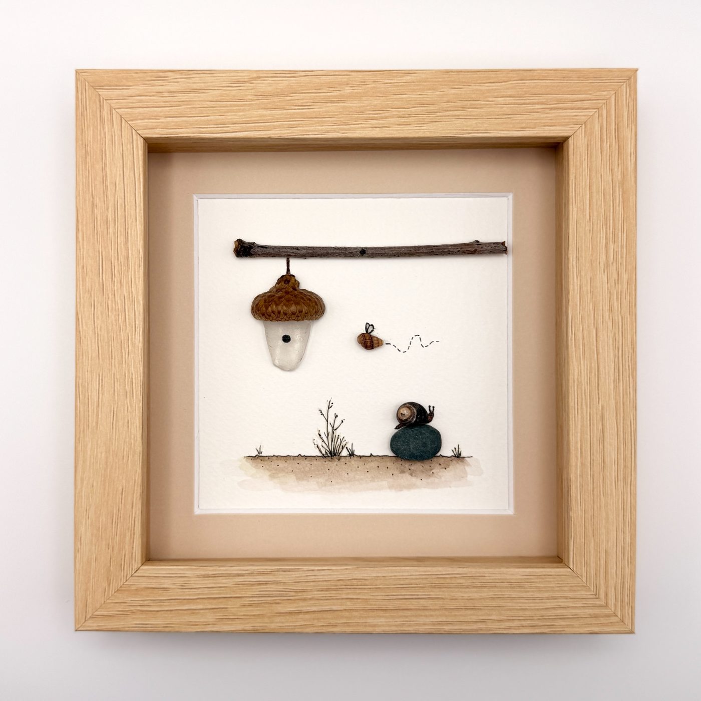 Hanging acorn house with a bee and snail