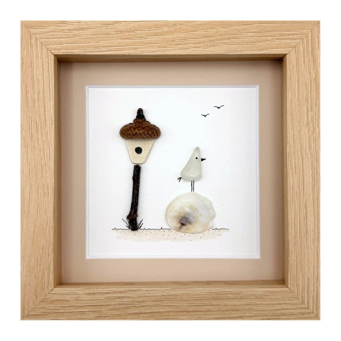 Sea glass bird beside an acorn lamp