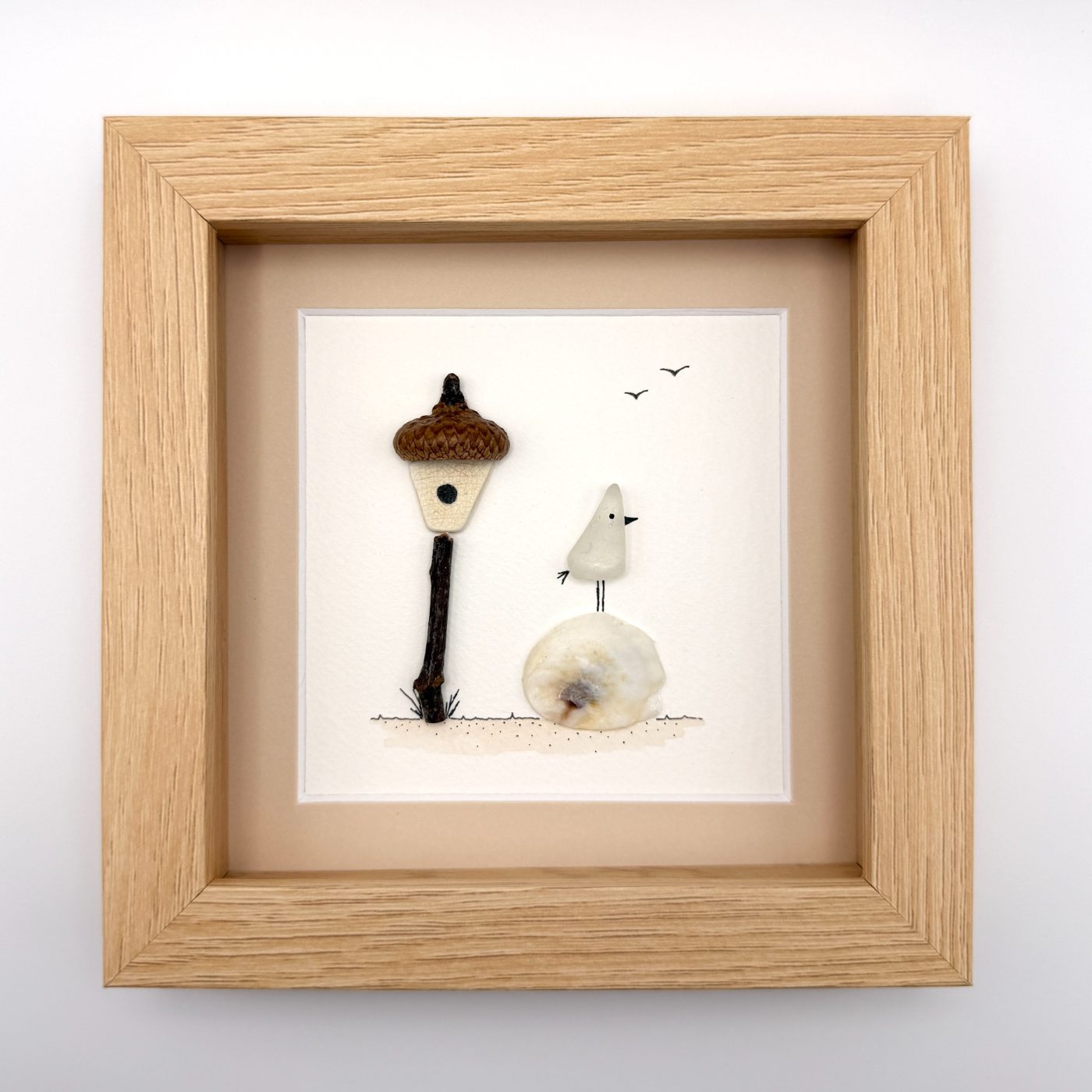 Sea glass bird beside an acorn lamp
