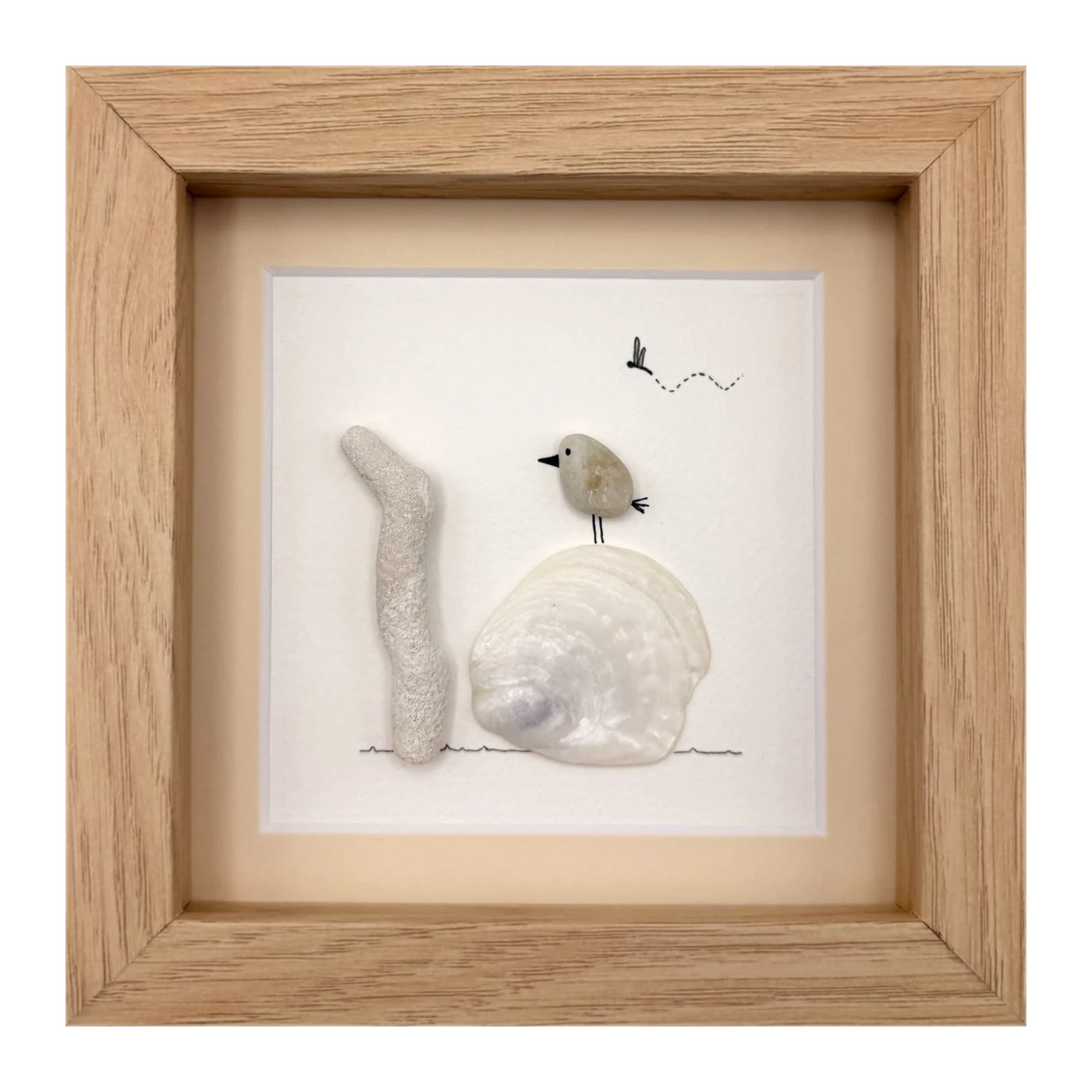 Pebble bird on a white clam shell