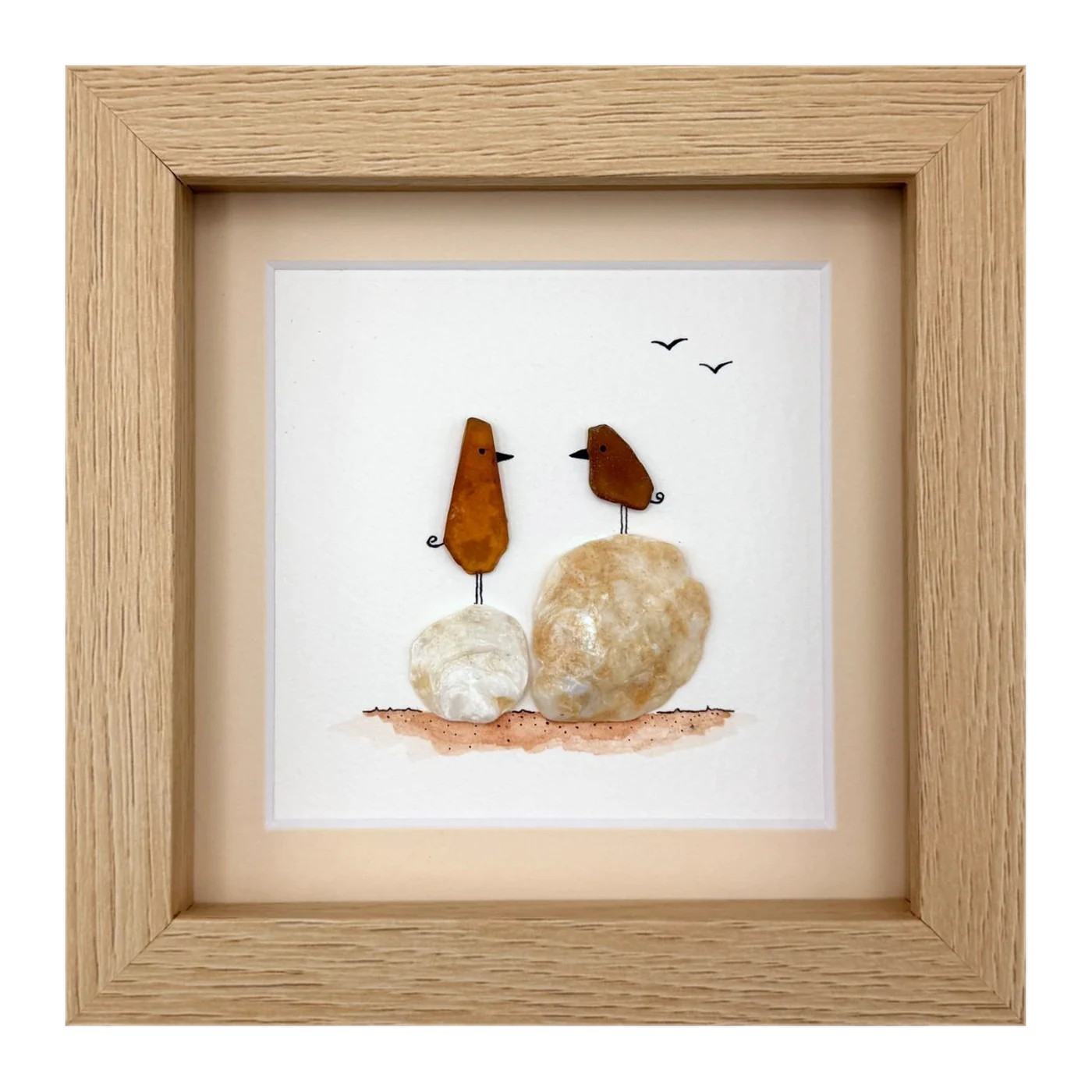 Two amber sea glass birds on shells