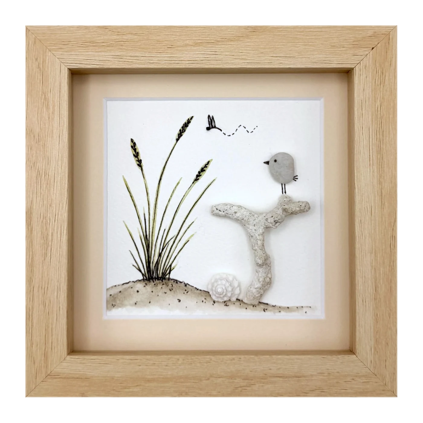 Pebble bird on coral beside dune grass