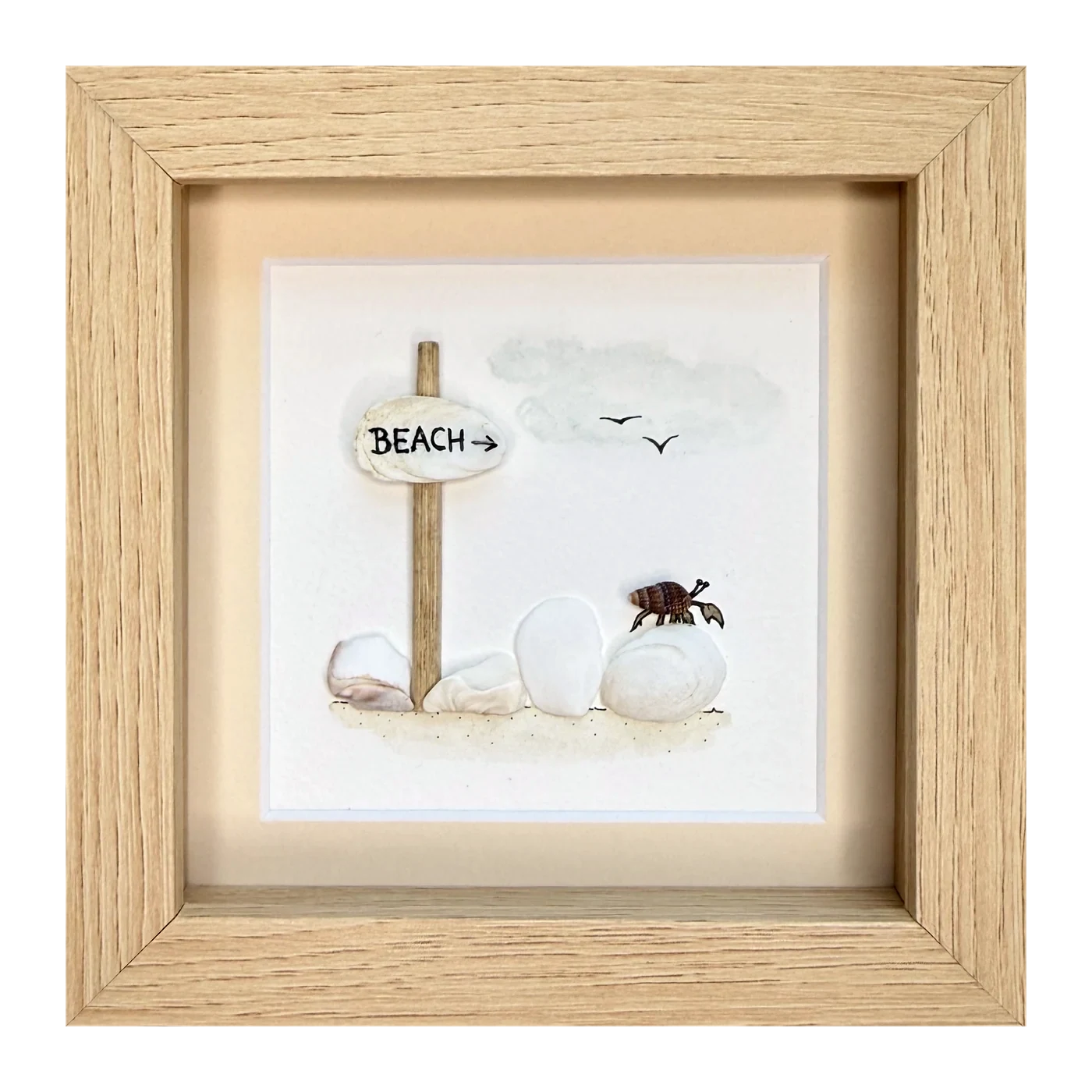 A hermit crab on a white stone beside a shell beach sign on a driftwood post, with two gulls overhead