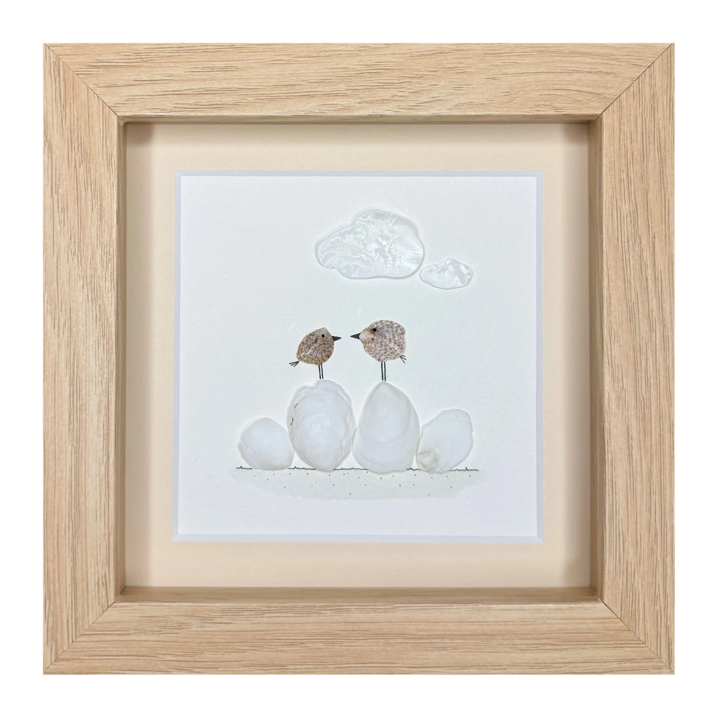 Two speckled shell birds face to face on white shells, under two shell clouds
