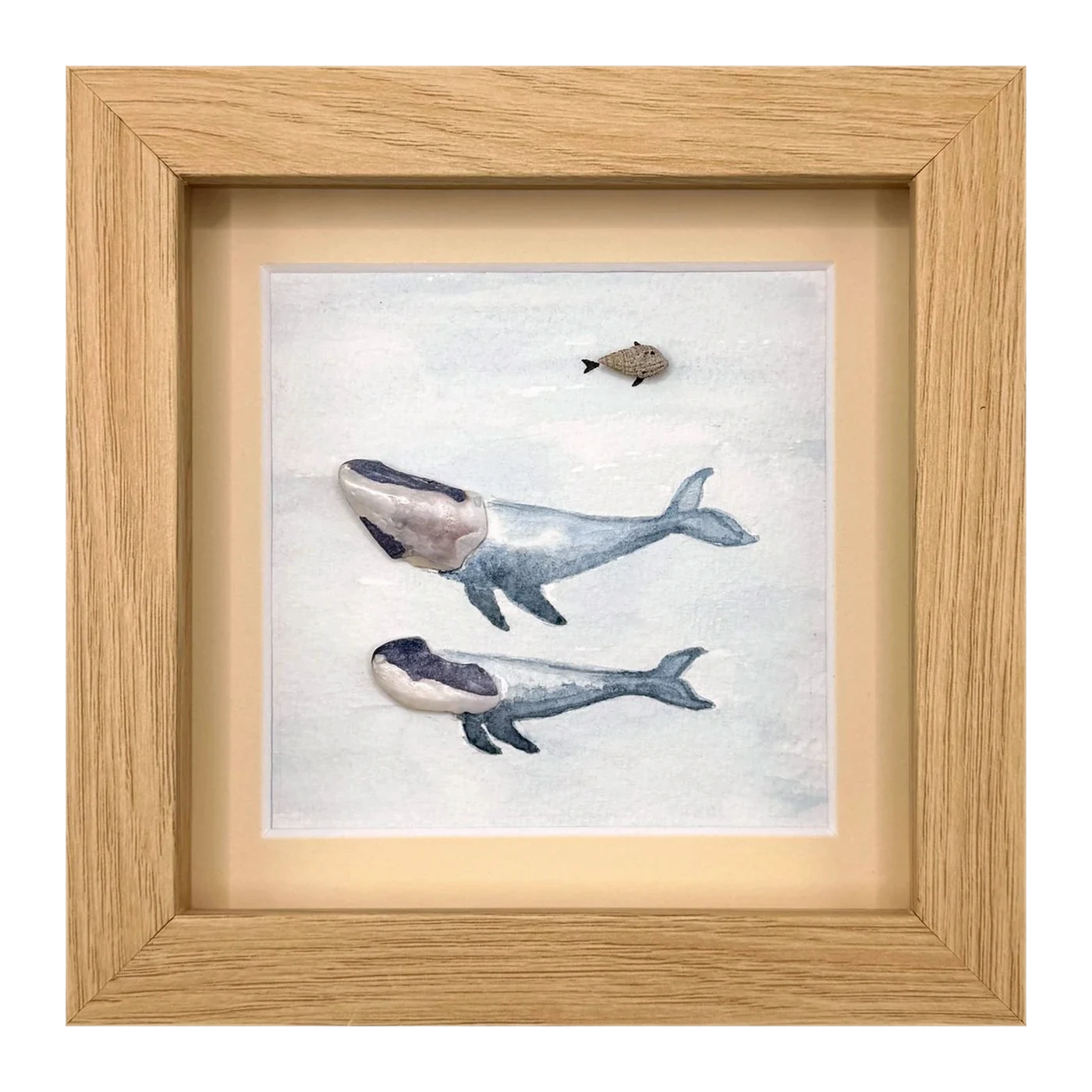 Two shell whales with a small pebble fish above them